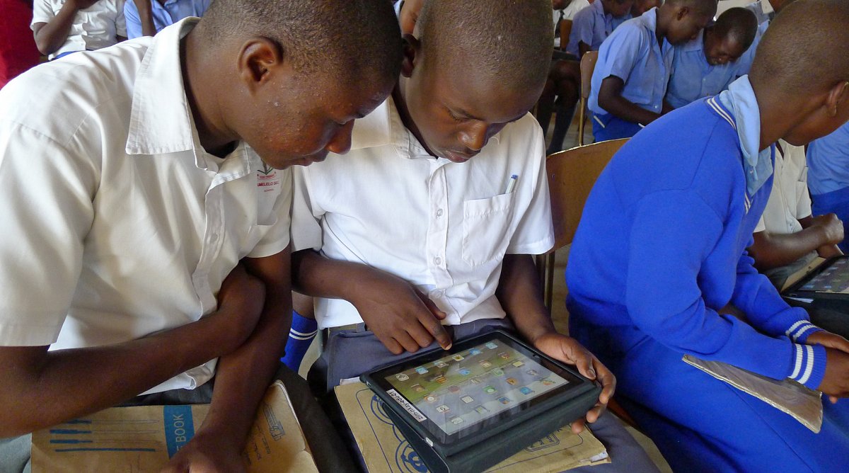 Schüler in Simbabwe lernen den Umgang mit iPads.