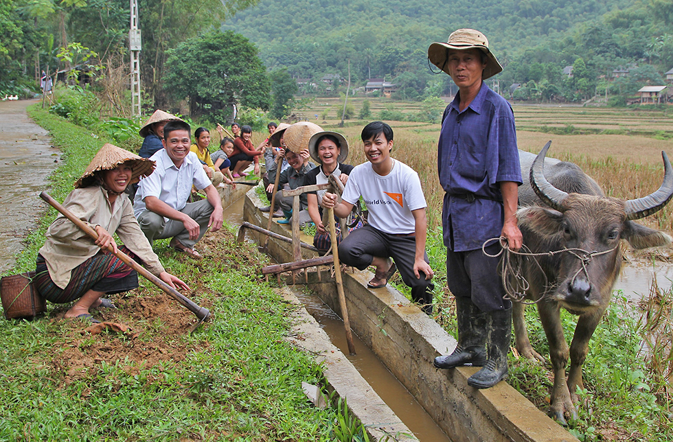 Dorfbewohner arbeiten an einem Kanal zur Bewässerung ihrer Reisfelder in Quan Son, Vietnam