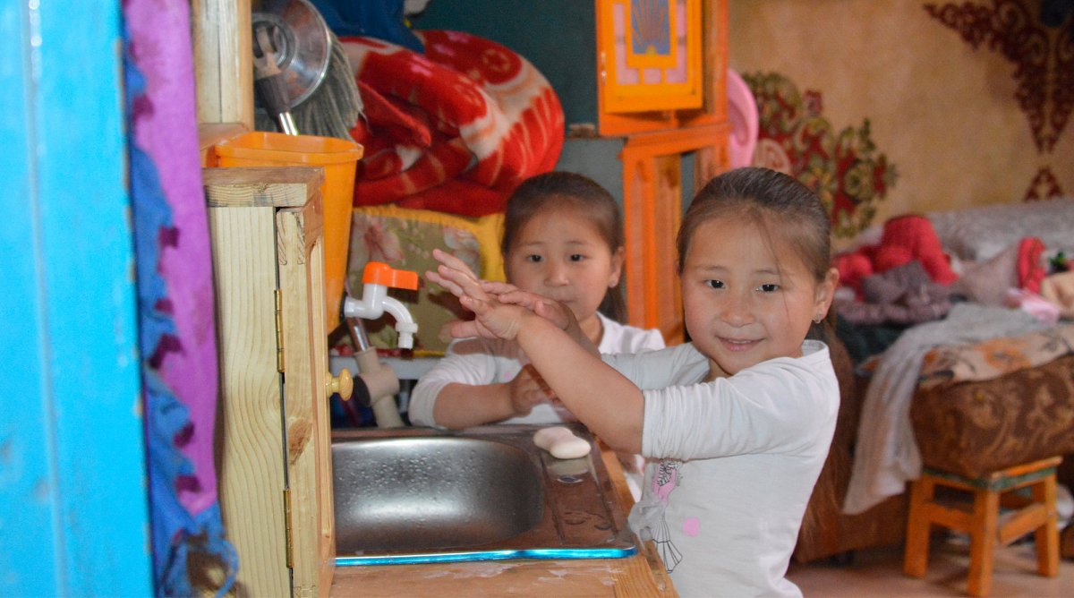 Mongolei: Zwei Mädchen waschen sich an einem Spülbecken die Hände, um sich vor dem Coronavirus zu schützen.